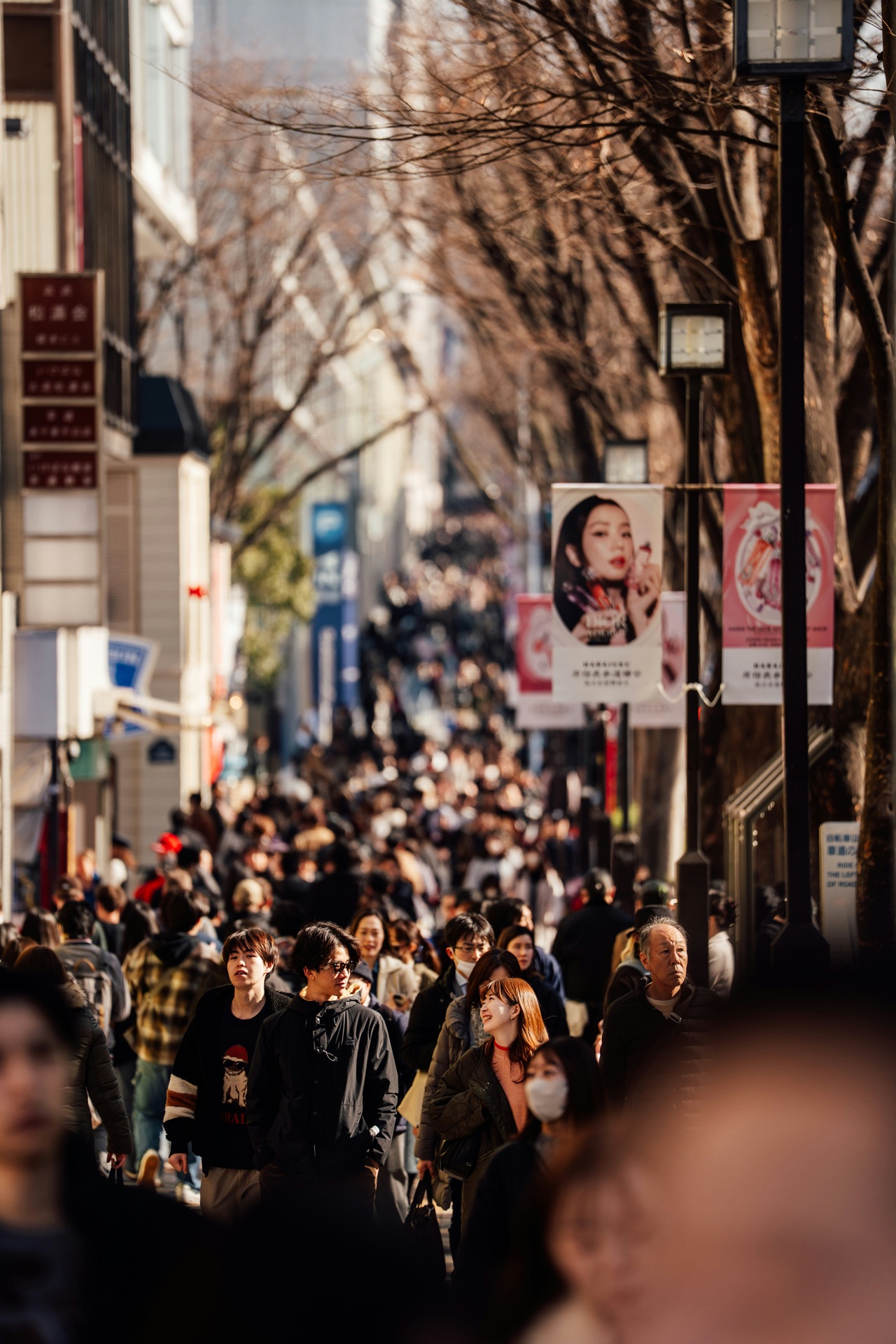 Crowded street scene with people walking through a city