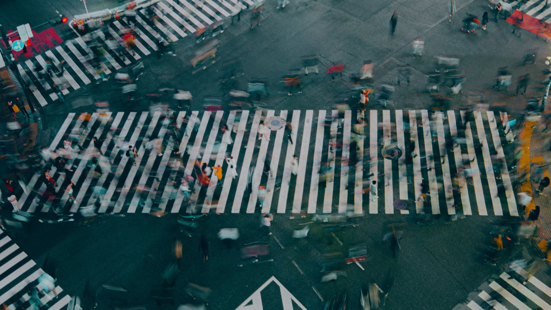 Aerial view of a busy crosswalk with motion blur